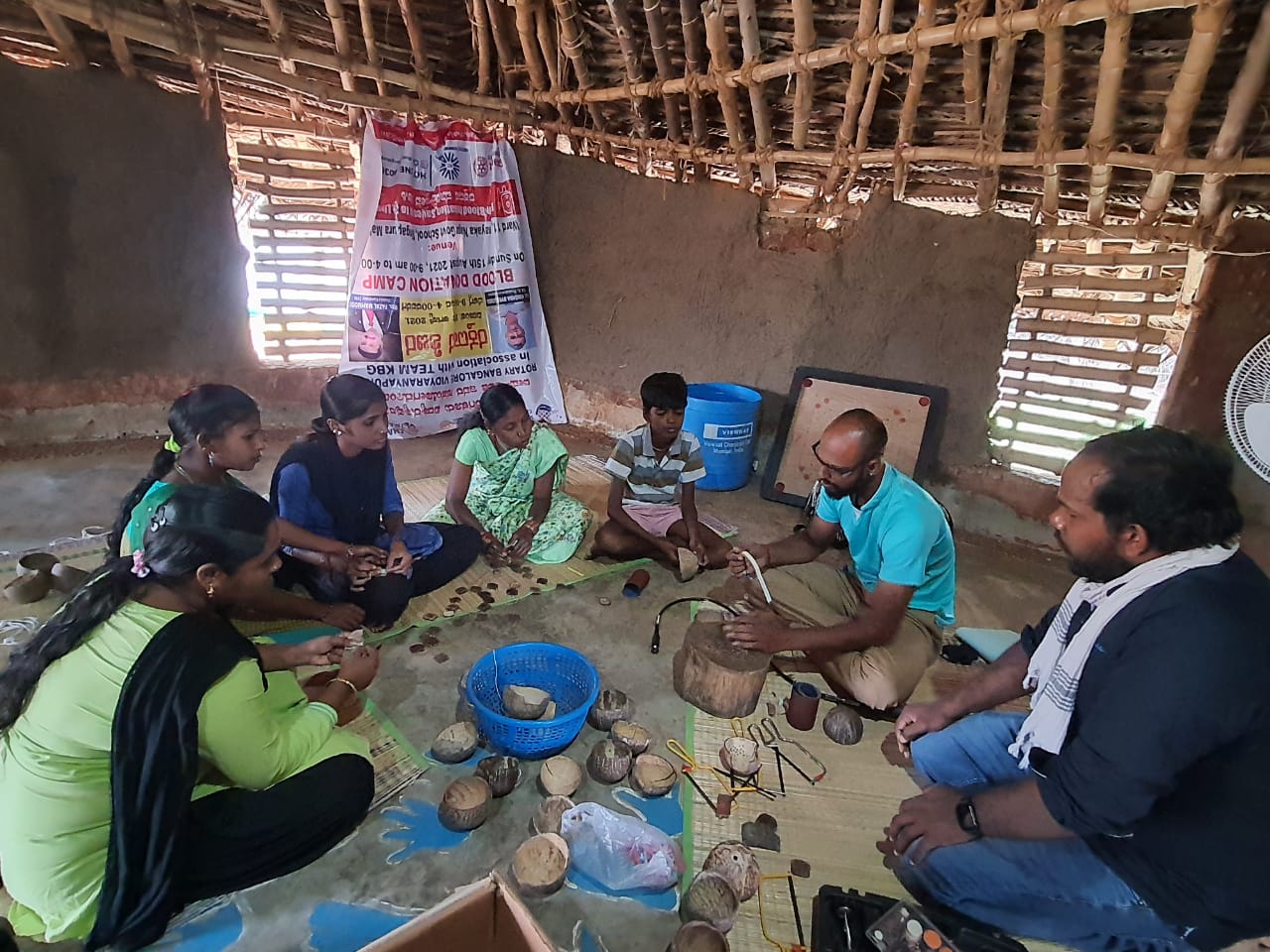 Inara workforce being trained in making handicrafts with coconut shells in a small wooden hut