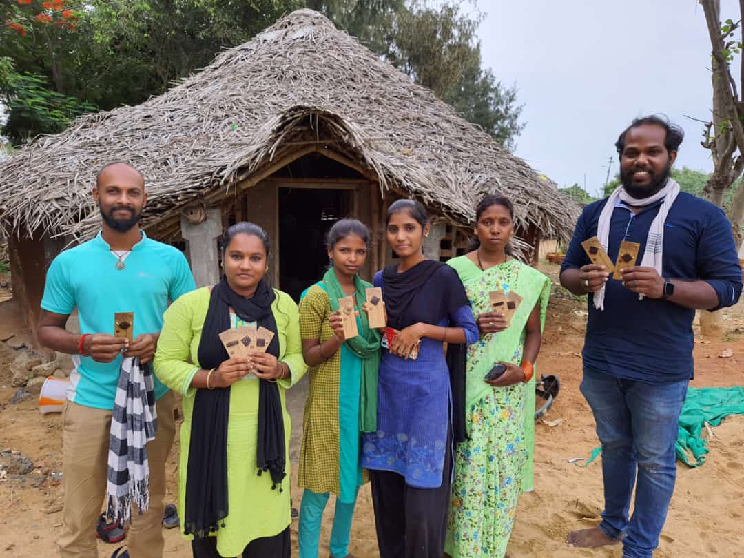 Inara workforce holding Rakhis in their hands while smiling at the camera