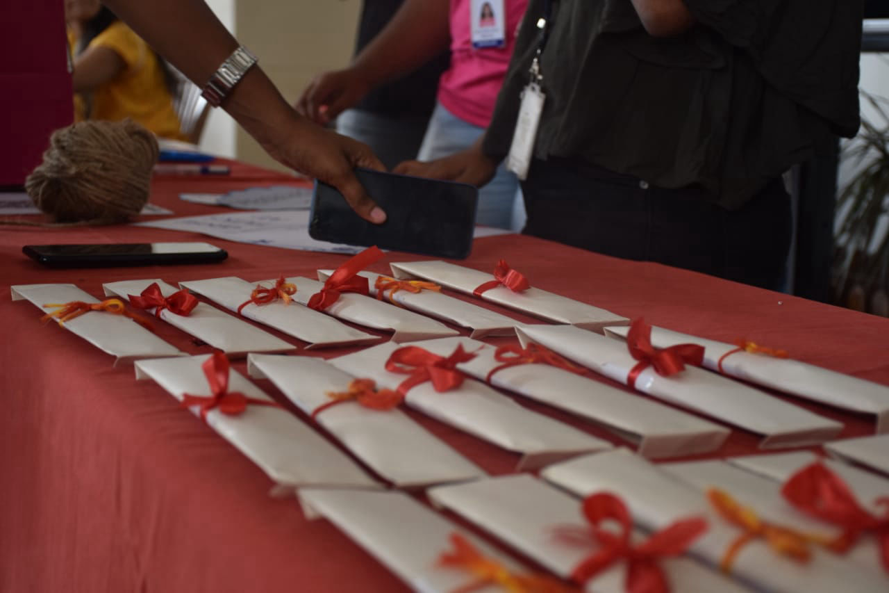 Products in envelopes tied with red ribbons