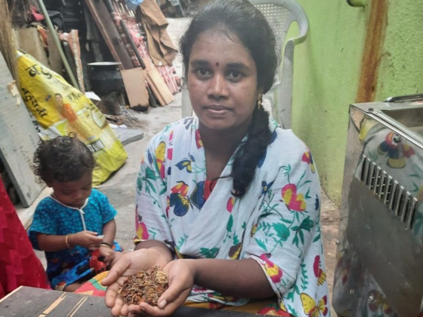 A member of our workforce holding incense stick material in her cupped hands